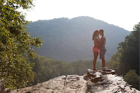 simsearch:649-07437125,k - Young couple kissing on rock ledge, Hamburg, Pennsylvania, USA Stock Photo - Premium Royalty-Free, Code: 614-07194670