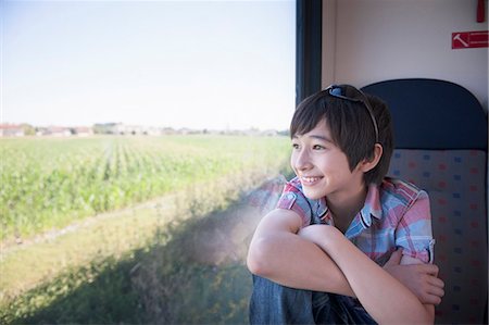 portrait boy arms crossed - Boy looking out of train window Stock Photo - Premium Royalty-Free, Code: 614-07194697