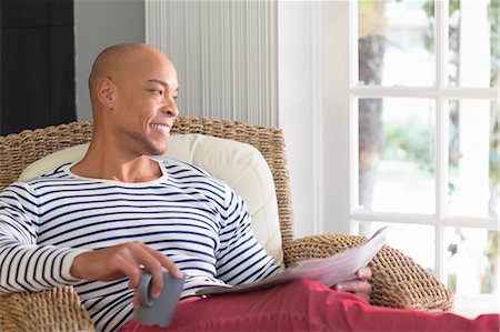 paper cup of coffee - Mid adult man sitting in wicker chair Stock Photo - Premium Royalty-Free, Code: 614-07194707