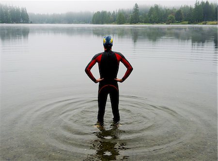 simsearch:614-07194789,k - Young man in wet suit preparing to swim lake Stock Photo - Premium Royalty-Free, Code: 614-07194789