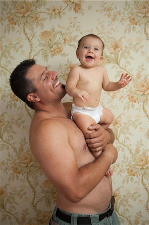 Grandfather holding baby granddaughter Stock Photo - Premium Royalty-Free, Code: 614-07194783