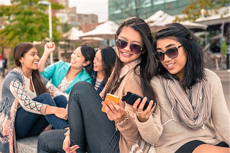 Young women looking at smartphones Stock Photo - Premium Royalty-Free, Code: 614-07234777