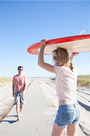 simsearch:614-07708168,k - Couple carrying surfboard on coastal path, Breezy Point, Queens, New York, USA Stock Photo - Premium Royalty-Free, Code: 614-07234824