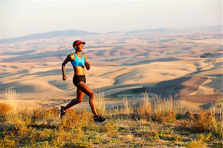 Young woman running on hill, Bainbridge Island, Washington State, USA Stock Photo - Premium Royalty-Free, Code: 614-07234908