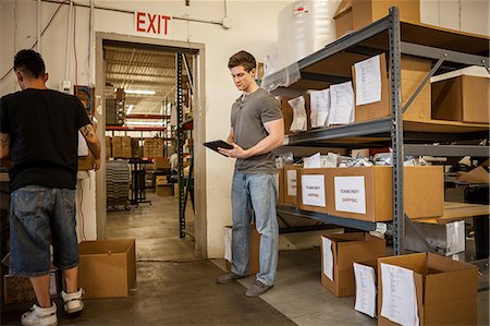 simsearch:614-07234972,k - Workers in warehouse looking at paperwork Stock Photo - Premium Royalty-Free, Code: 614-07234972