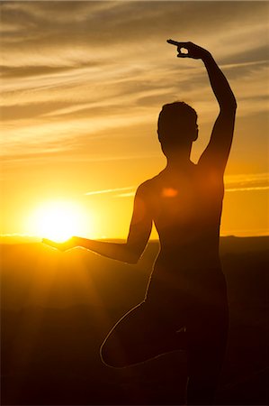sun - Young woman doing yoga in sunlight, Moab, Utah, USA Stock Photo - Premium Royalty-Free, Code: 614-07239927