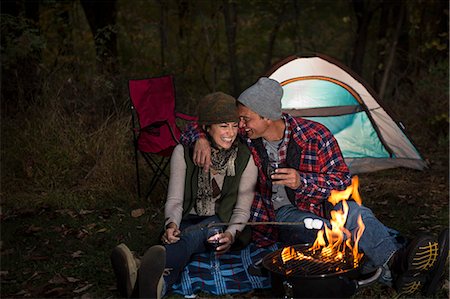 escape - Mature couple sitting outside tent with barbecue and glass of wine Stock Photo - Premium Royalty-Free, Code: 614-07239984