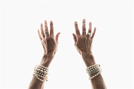 Studio shot of mature woman's reaching hands Photographie de stock - Premium Libres de Droits, Code: 614-07240049