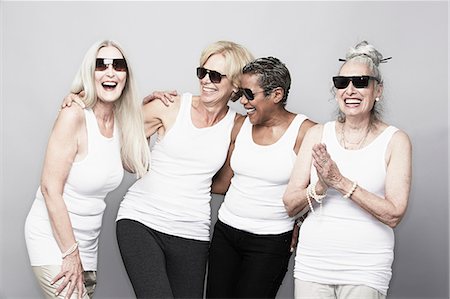 fun older people indoors - Studio portrait of senior women friends in sunglasses Stock Photo - Premium Royalty-Free, Code: 614-07240040