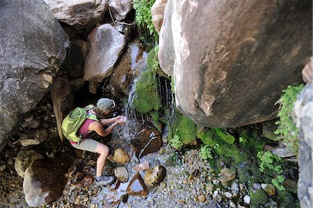 Female hiker drinking from waterfall, Mount Wilson, Red Rock Canyon, Nevada, USA Stock Photo - Premium Royalty-Free, Code: 614-07240107