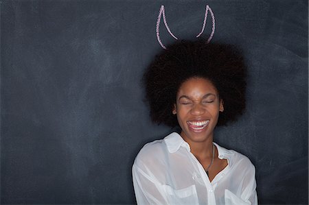 devil - Young woman by blackboard with horns Photographie de stock - Premium Libres de Droits, Code: 614-07240142