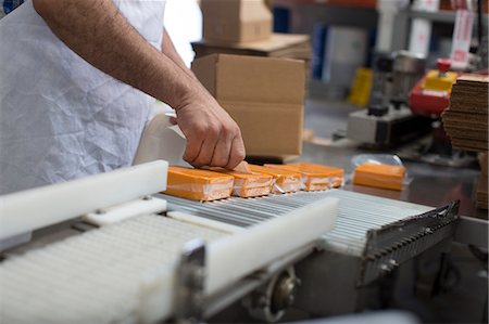 Man packaging vegan cheese in warehouse Stock Photo - Premium Royalty-Free, Code: 614-07240187