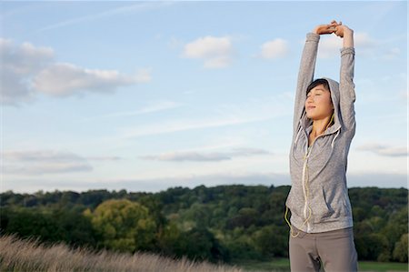 simsearch:614-07444008,k - Young female runner stretching arms Foto de stock - Sin royalties Premium, Código: 614-07444028