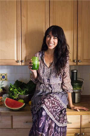 portrait hippies - Young woman in kitchen with vegetable juice Stock Photo - Premium Royalty-Free, Code: 614-07444235