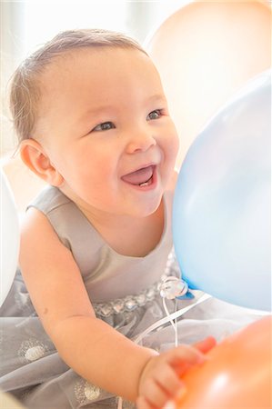 Baby girl wearing party dress with balloon Stock Photo - Premium Royalty-Free, Code: 614-07444241