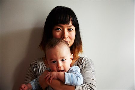 Portrait of mother holding baby boy Stock Photo - Premium Royalty-Free, Code: 614-07444293