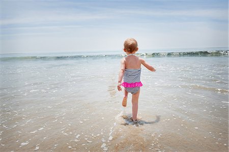 Female toddler running into the sea Stock Photo - Premium Royalty-Free, Code: 614-07444322