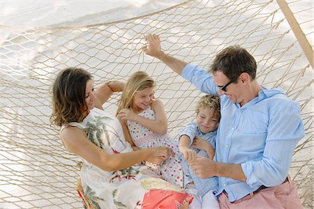 Family relaxing in beach hammock, Providenciales, Turks and Caicos Islands, Caribbean Stock Photo - Premium Royalty-Free, Code: 614-07453291