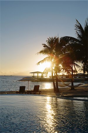 Sunset at coastal resort, Providenciales, Turks and Caicos Islands, Caribbean Stockbilder - Premium RF Lizenzfrei, Bildnummer: 614-07453401