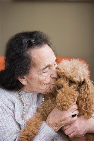 Senior woman kissing dog Stock Photo - Premium Royalty-Free, Code: 614-07453450