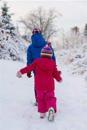 pink girl tree - Brother and sister walking in snow Stock Photo - Premium Royalty-Free, Code: 614-07486901