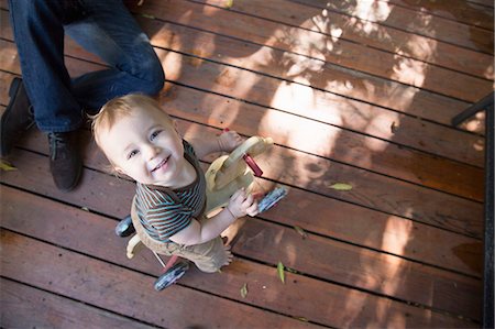 Baby riding on toy horse Stock Photo - Premium Royalty-Free, Code: 614-07486926