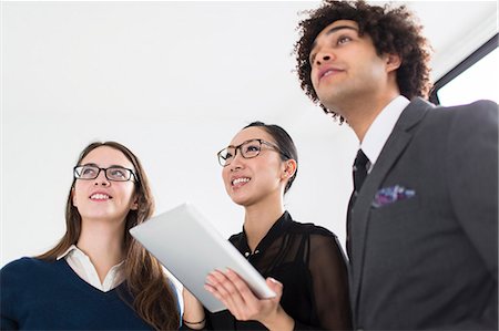 people organization - Three colleagues using digital tablet Stock Photo - Premium Royalty-Free, Code: 614-07487046