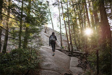 forest bathing - Young woman walking through forest, Squamish, British Columbia, Canada Stock Photo - Premium Royalty-Free, Code: 614-07487135