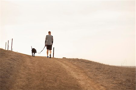 dog man - Man walking dog Stock Photo - Premium Royalty-Free, Code: 614-07487133