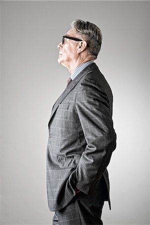 Portrait of senior man, wearing suit, side view Stock Photo - Premium Royalty-Free, Code: 614-07487221