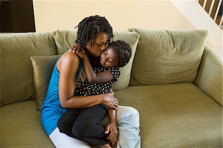 simsearch:6108-08662912,k - Mature woman and daughter hugging on sofa Stock Photo - Premium Royalty-Free, Code: 614-07487236