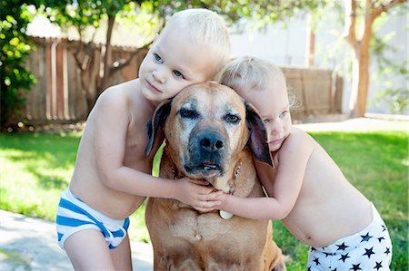 people hugging dogs - Portrait of old dog and toddler twins Stock Photo - Premium Royalty-Free, Code: 614-07587564