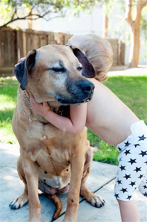 female and dog companion - Female toddler hugging old dog Stock Photo - Premium Royalty-Free, Code: 614-07587563