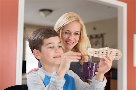 family home single parent - Mother admiring sons hand made model Stock Photo - Premium Royalty-Free, Code: 614-07587662