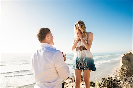 Young man proposing to girlfriend by sea, Torrey Pines, San Diego, California, USA Stock Photo - Premium Royalty-Free, Code: 614-07652172