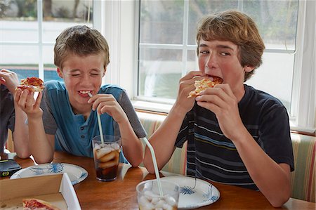 drinking smile boy - Boys eating pizza Stock Photo - Premium Royalty-Free, Code: 614-07652246