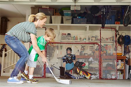 pictures of family play sports - Mother playing hockey in garage with two sons Stock Photo - Premium Royalty-Free, Code: 614-07652251