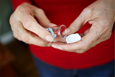 pharmaceutics - Close up of 82 year old senior woman's hand with pill bottle Stock Photo - Premium Royalty-Free, Code: 614-07652269