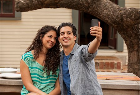 Couple taking self portrait photograph using smartphone Stock Photo - Premium Royalty-Free, Code: 614-07652462