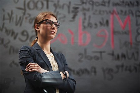 Portrait of businesswoman wearing jacket with writing Stock Photo - Premium Royalty-Free, Code: 614-07652548