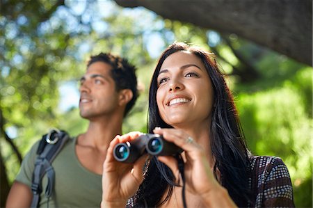 Couple with binoculars birdwatching in forest Stock Photo - Premium Royalty-Free, Code: 614-07708132