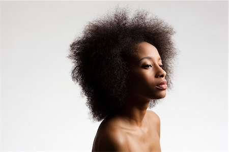 poised (self collected) - Studio shot of young woman with afro Stock Photo - Premium Royalty-Free, Code: 614-07708150
