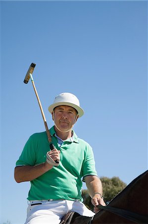 Portrait of mature man playing polo Stock Photo - Premium Royalty-Free, Code: 614-07708237