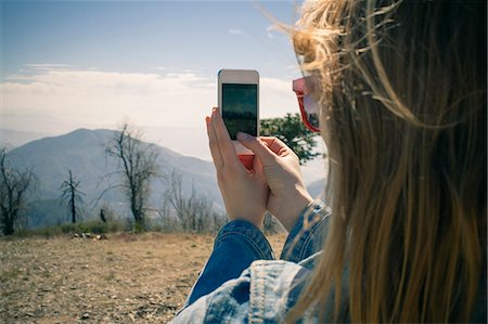 remote cellphone - Cropped shot of mid adult woman photographing view on smartphone, Lake Arrowhead, California, USA Stock Photo - Premium Royalty-Free, Code: 614-07708322