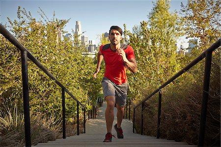 running in city - Young male runner running up park steps Stock Photo - Premium Royalty-Free, Code: 614-07735155