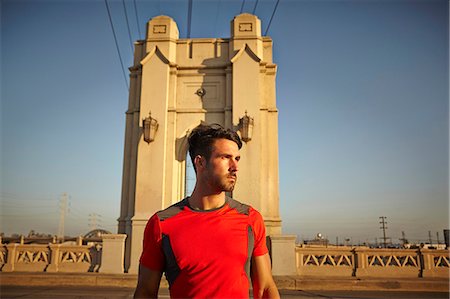 Young male runner taking a break at city bridge Stock Photo - Premium Royalty-Free, Code: 614-07735156