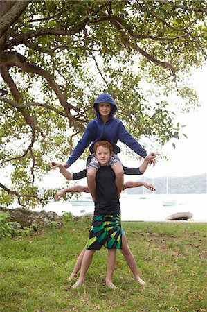 simsearch:614-07735202,k - Portrait of three boys, one behind and another on shoulders Stock Photo - Premium Royalty-Free, Code: 614-07735203
