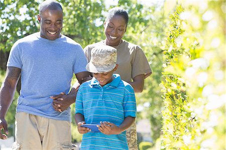 Female soldier strolling with family on homecoming Stock Photo - Premium Royalty-Free, Code: 614-07735273