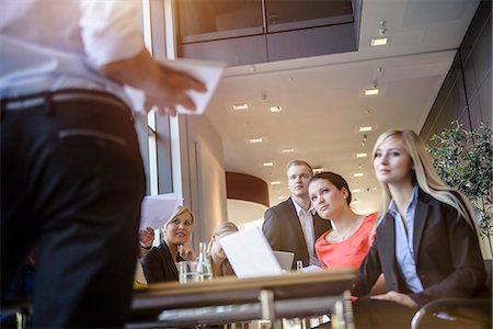 presenting - Businessmen and businesswomen at brainstorming meeting Stock Photo - Premium Royalty-Free, Code: 614-07735335