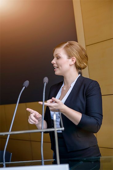 Young businesswoman speaking in conference meeting Stock Photo - Premium Royalty-Free, Image code: 614-07735365
